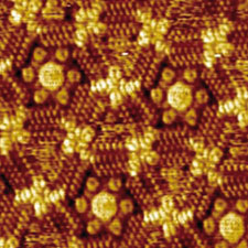 Triangular and hexagonal pores arranged around different combinations of template molecules